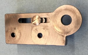 Sliding block mounted with retaining screw